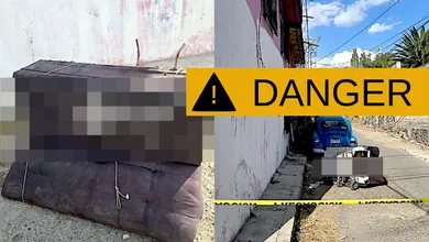 Policías acordonan una calle de Tecámac tras el hallazgo de un cadáver en sillón abandonado sobre un diablito.