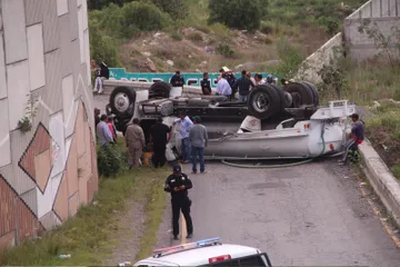 Pipa de agua volcada sobre puente en San Agustín Tlaxiaca.
